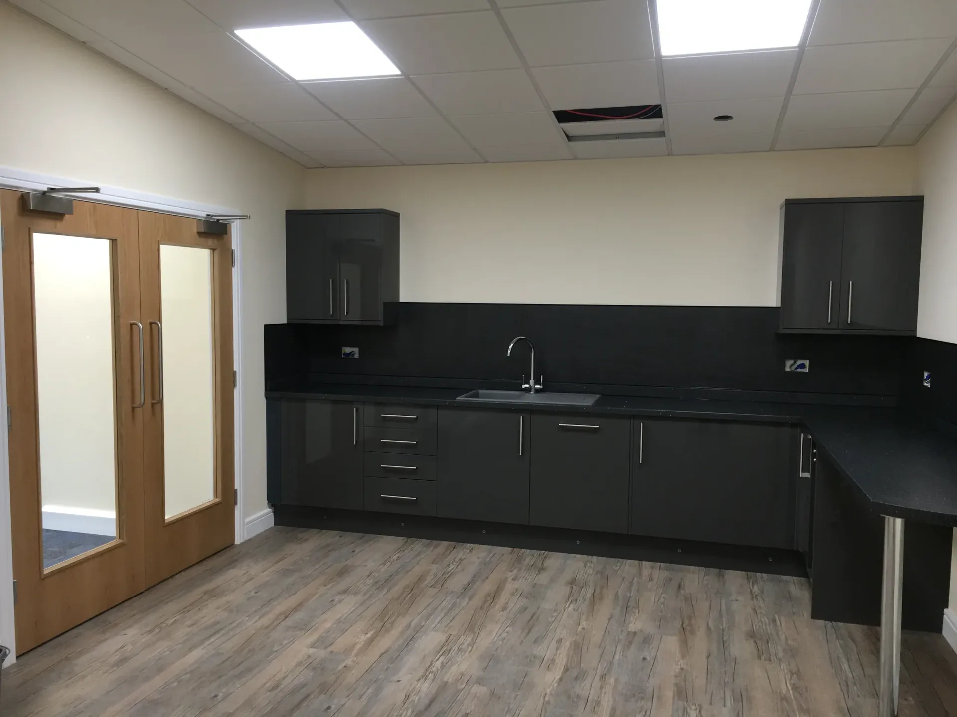 Kitchen area with double doors and fitted units