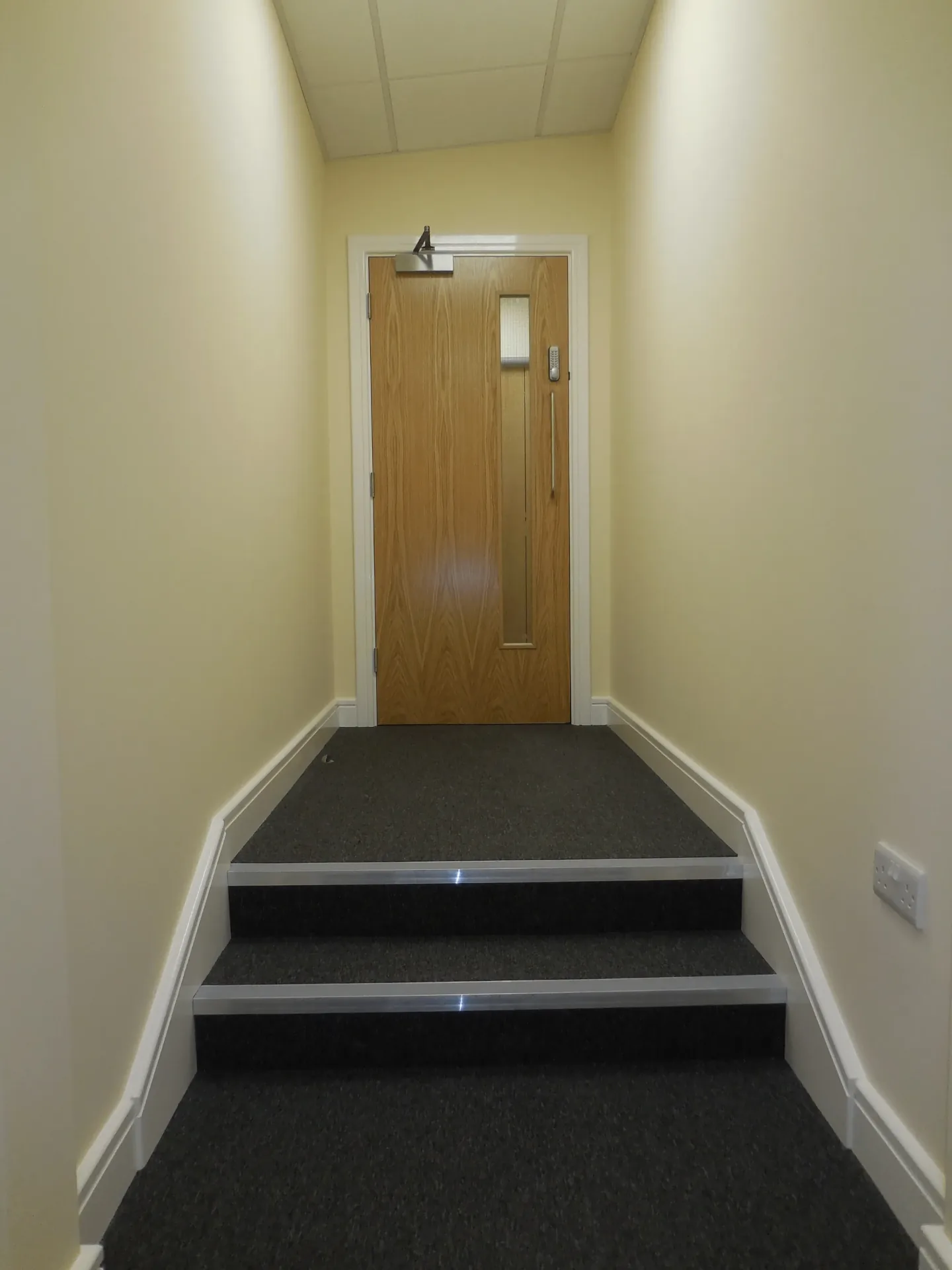Stair landing leading to an internal secure door